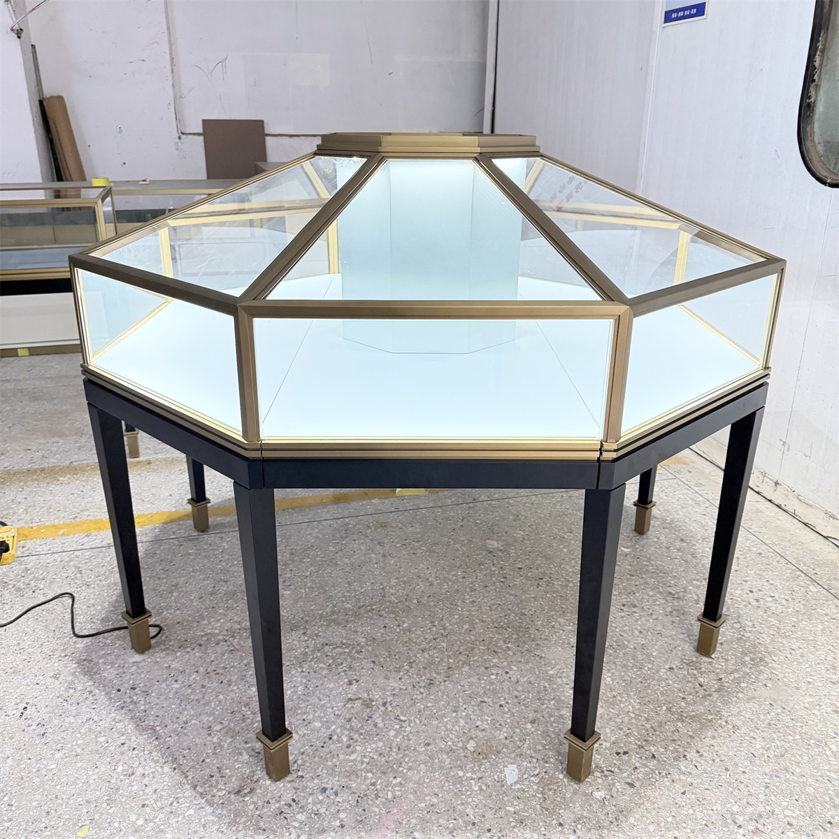 Factory test of Custom Octagonal Jewelry Showcases featuring tempered glass and high-end LED lighting system